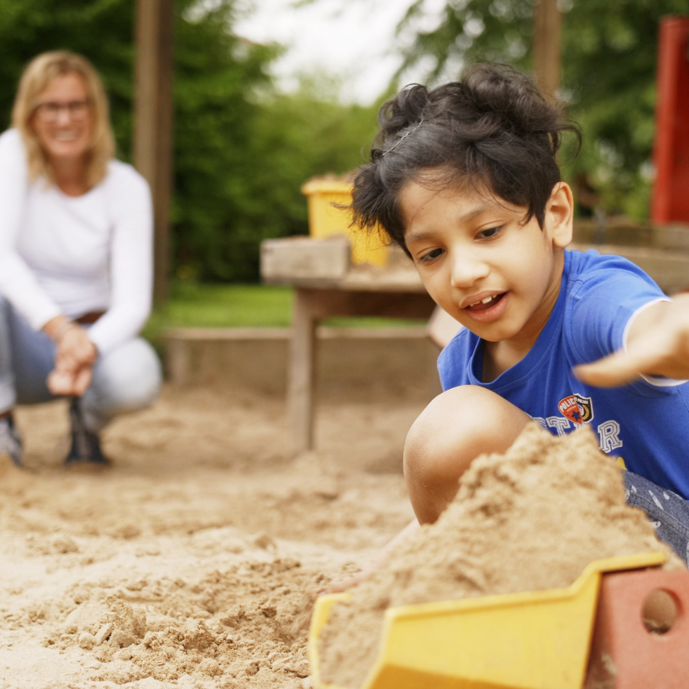 Junge spielt mit Sand Junge spielt mit Sand